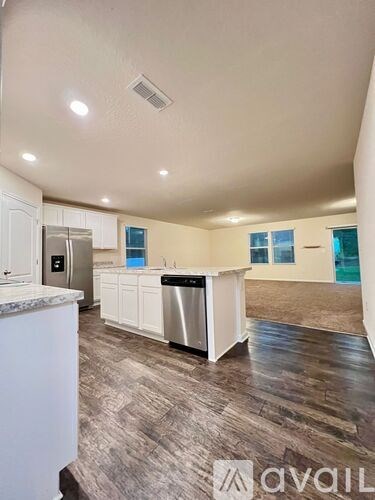 A kitchen with white cabinets and a stainless steel dishwasher.