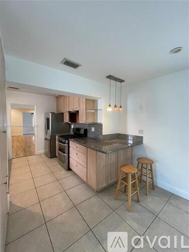A kitchen with wooden cabinets and a black countertop.
