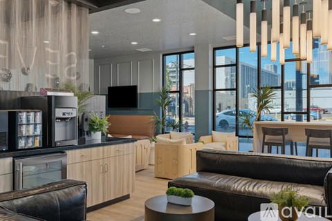 A modern living room with a black leather couch and a wooden coffee table.
