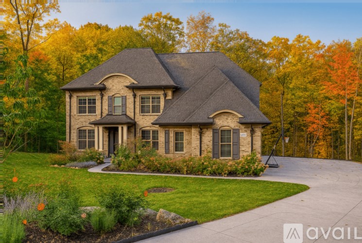 A house with a driveway and a garden in front.