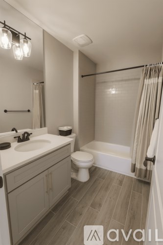 A bathroom with a sink, toilet, and bathtub.
