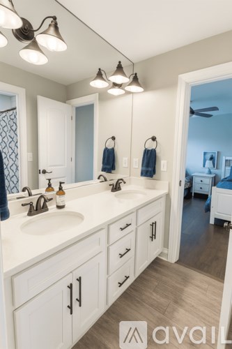 A bathroom with two sinks and a mirror.