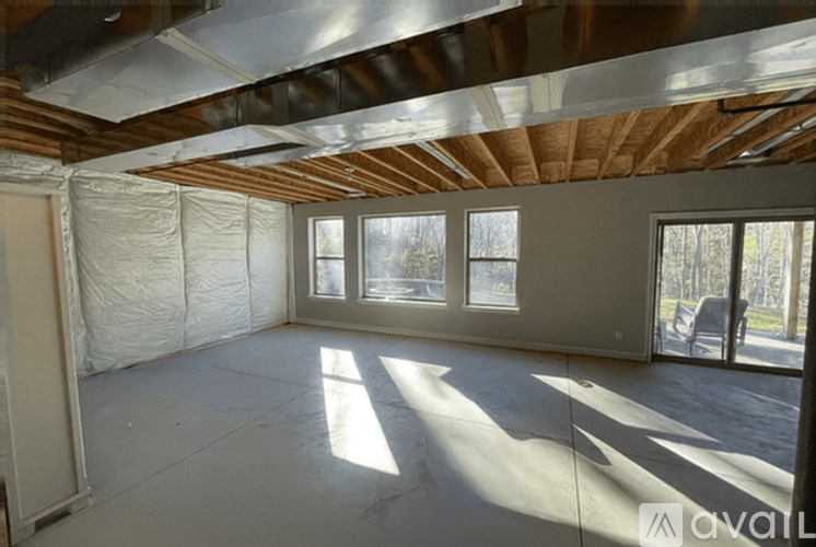 A room with a wooden ceiling and a wall covered in insulation material.