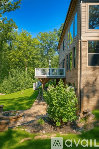 A house with a basketball hoop in the driveway.