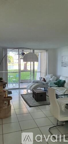 A living room with a white couch and a coffee table.
