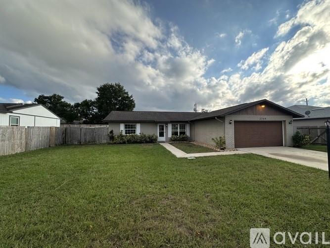 A house with a brown garage door is for sale.