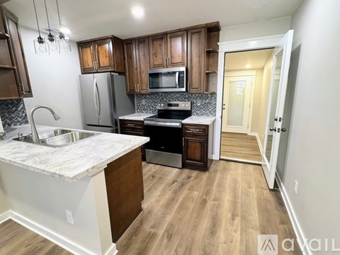 A kitchen with wooden cabinets and a white countertop.