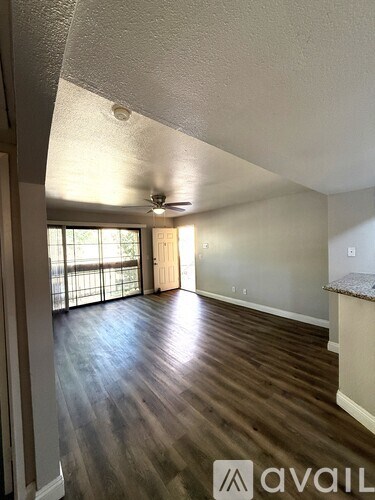 A room with wooden floors and a ceiling fan.