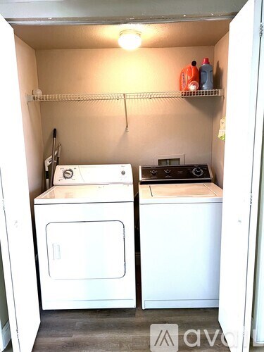 A small laundry room with a washer and dryer.