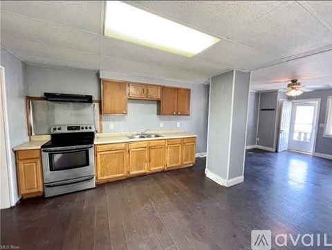 A kitchen with wooden cabinets and a stove top oven.