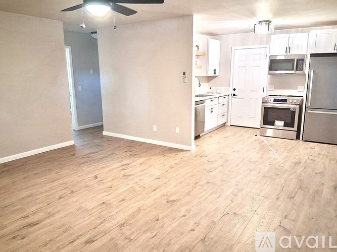A kitchen with wooden floors and stainless steel appliances.