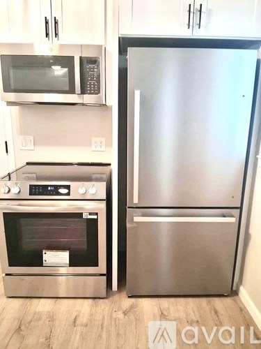 A kitchen with a stainless steel refrigerator and oven.
