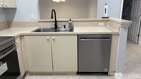 A kitchen with a sink and a dishwasher.