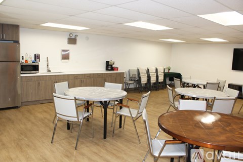 A conference room with a table and chairs.