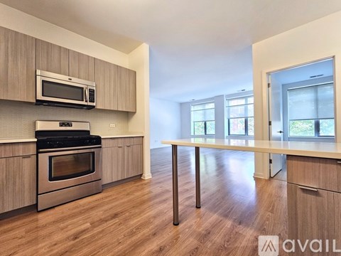 A kitchen with wooden cabinets and a stainless steel oven.