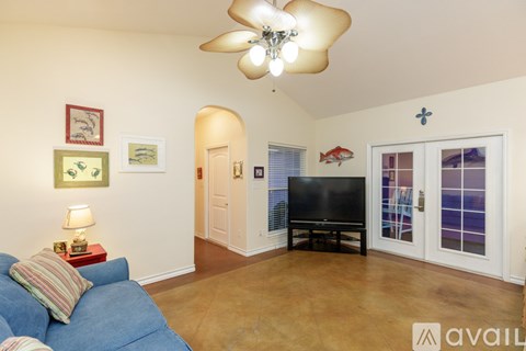 A living room with a blue couch and a flat screen TV.