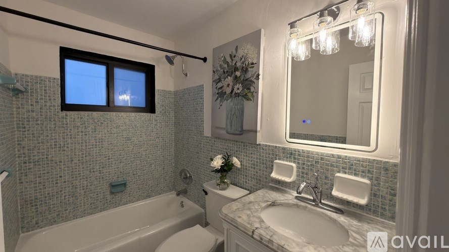 A kitchen with white walls and a wooden counter.
