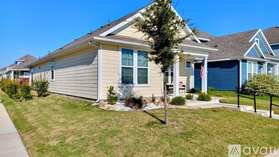 A house with a front yard and a porch.
