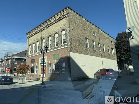 A building with a red car parked in front of it.