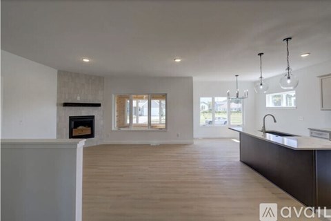 A modern kitchen with wooden floors and a large island.