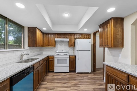 A kitchen with wooden cabinets and a white refrigerator.