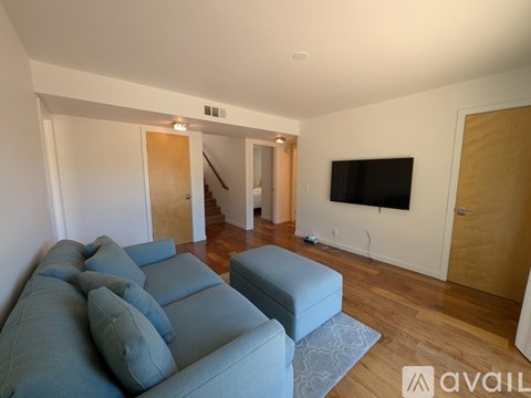 A living room with a grey couch and a television.