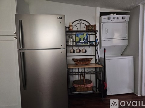 A kitchen with a stainless steel refrigerator and a white oven.