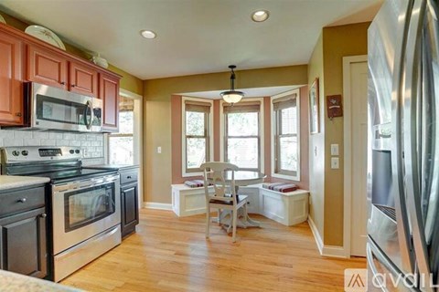 A kitchen with wooden cabinets and a black stove top oven.