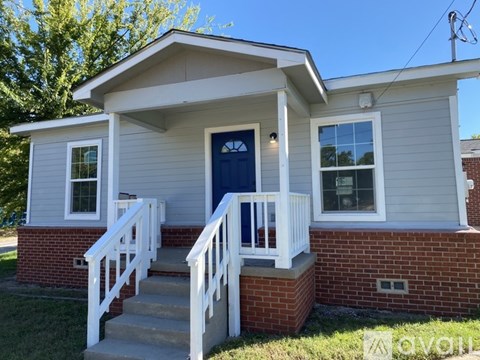 A house with a blue door and white railings.