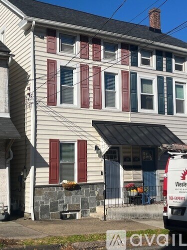 A house with a van parked in front of it.
