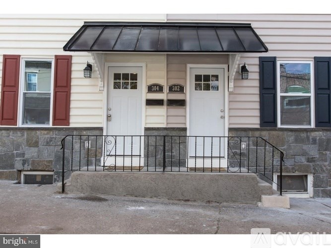 A house with a white door and a black awning.