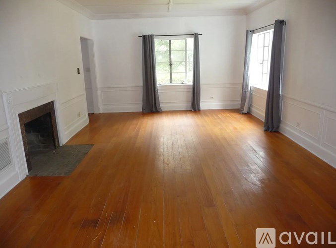 A room with wooden floors and a fireplace.