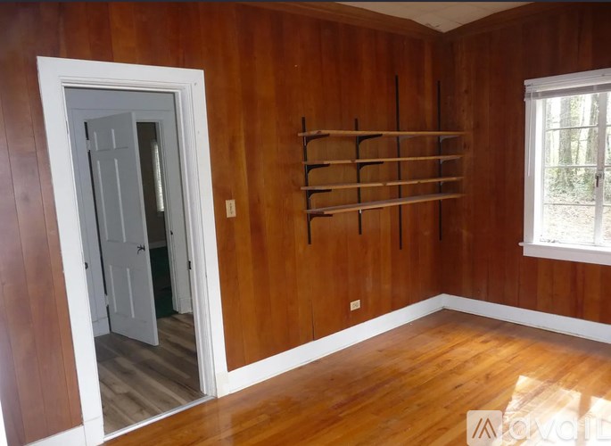 A room with wooden walls and a white door.