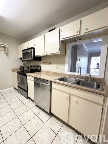 A kitchen with white cabinets and a granite counter top.