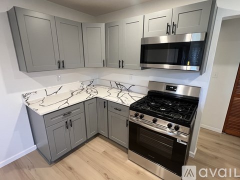 A kitchen with a stove top oven and a microwave above it.
