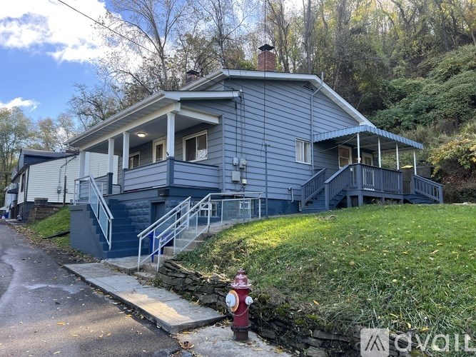 A blue house with a red fire hydrant in front.