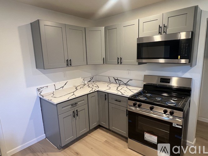 A kitchen with a stove and cabinets.