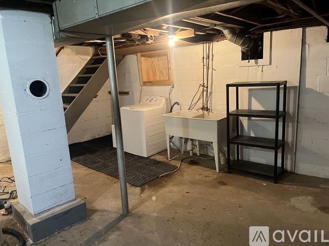 A room with a staircase and a white cabinet.