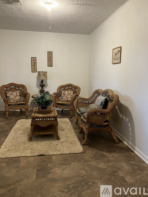 A room with a ceiling fan and a wooden barrier.