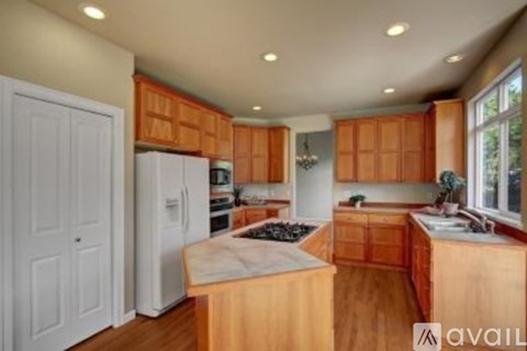 A kitchen with wooden cabinets and a white refrigerator.