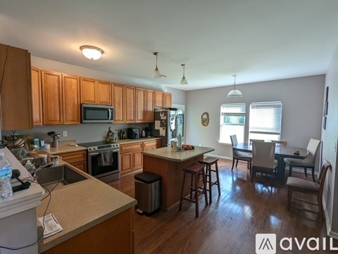 A kitchen with wooden cabinets and a countertop with a sink.