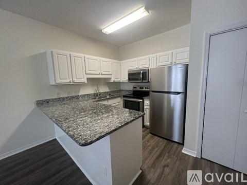 A kitchen with granite countertops and stainless steel appliances.
