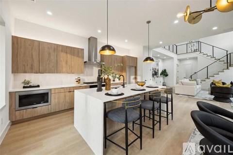 A modern kitchen with a dining table and chairs.