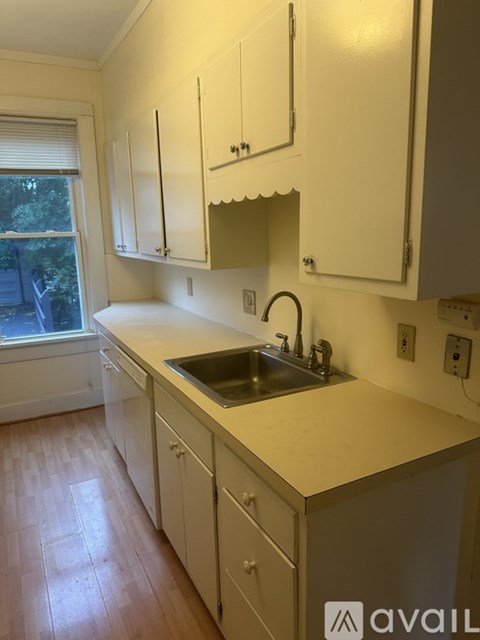A kitchen with a sink and cabinets.