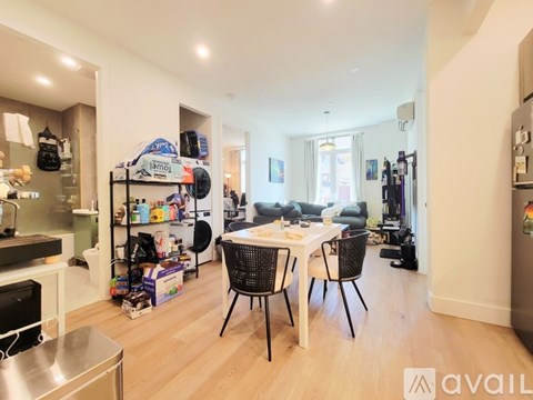 A kitchen with a dining table and chairs in the middle of the room.