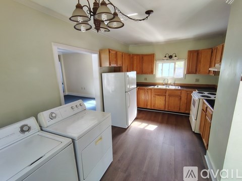 A kitchen with a washer and dryer stacked on top of each other.