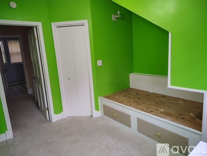 A room with green walls and a white door.