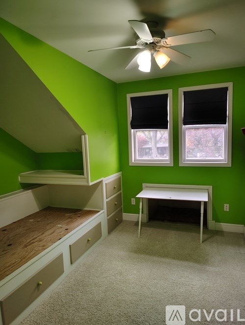 A room with green walls and a bunk bed.