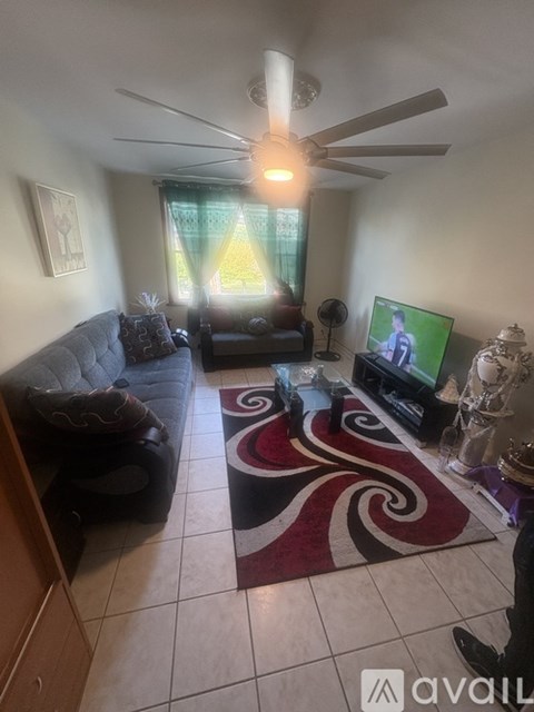 A living room with a television and a couch.