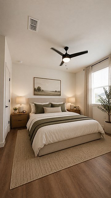 A bedroom with a large bed and a ceiling fan.